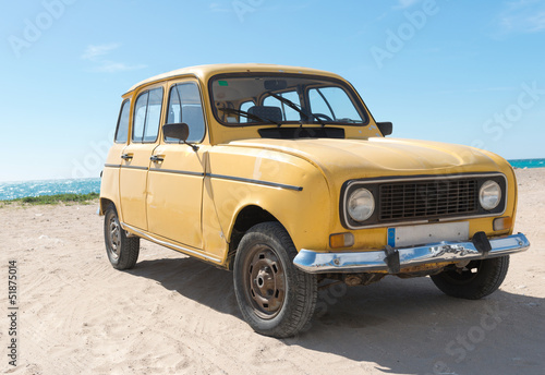 Yellow retro car by the sea