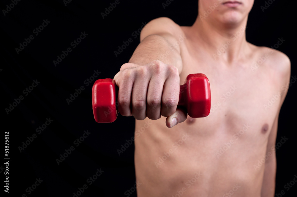 Young man trains muscles
