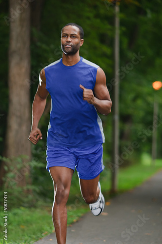 African American Athlete Running On A Wooded Path