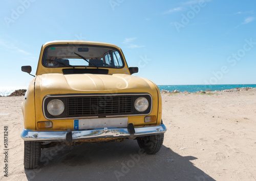Yellow retro car by the sea