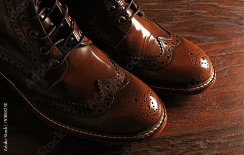 luxury brown shoes on wood background photo