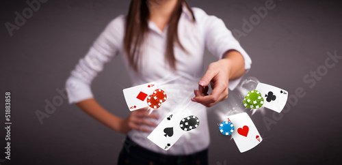 Young woman playing with poker cards and chips