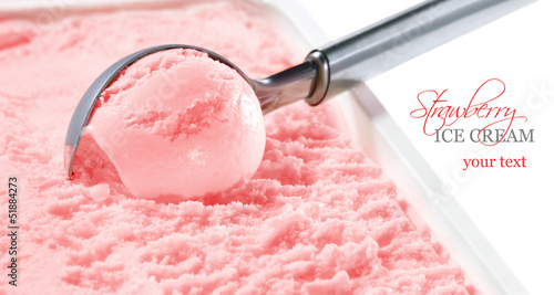 Strawberry ice cream scooped out of container