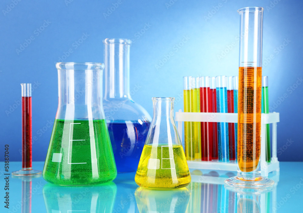 Test tubes with colorful liquids on blue background Test tubes with colorful liquids on blue background