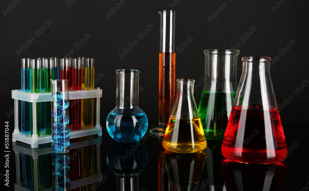 Test tubes with colorful liquids on dark grey background Test tubes with colorful liquids on dark grey background