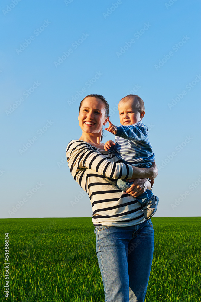 mom holding her son and smiling