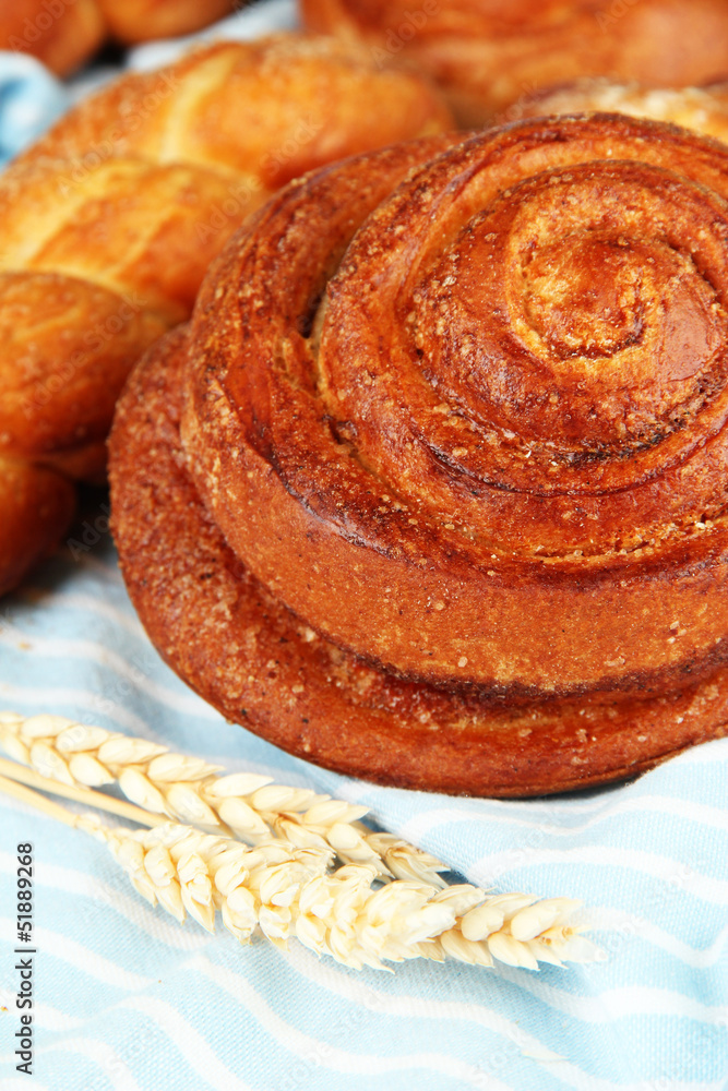 Fototapeta premium Composition with buns, on color napkin, close up