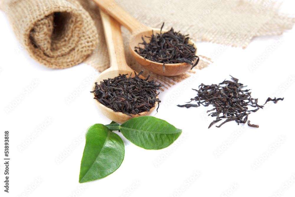 Wooden spoons with leaves tea and fresh green lemon leaf isolate Wooden spoons with leaves tea and fresh green lemon leaf isolate