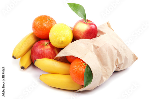 Fresh fruits in a paper bag isolated on a white background.