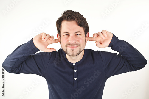 Obraz na płótnie young man covering ears from loud noise, isolated on white backg
