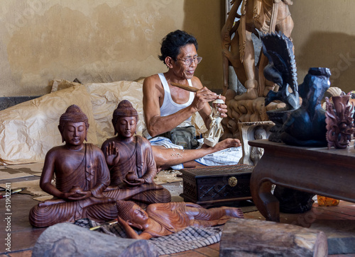 A man is making wooden crafts