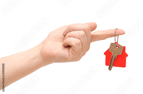 key with red home shape on chain in hand on white background