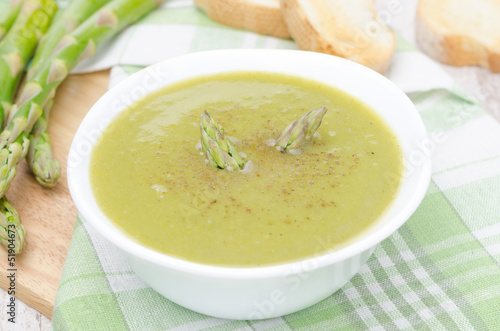 cream soup of asparagus and green peas with toasted bread