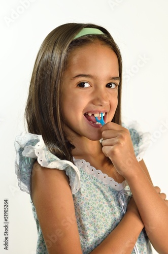 Little Hispanic Girl Flossing her Teeth