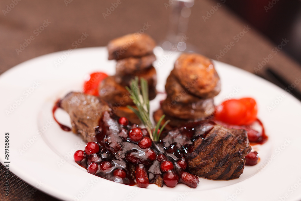 beef steak with potatoes and cranberry sauce