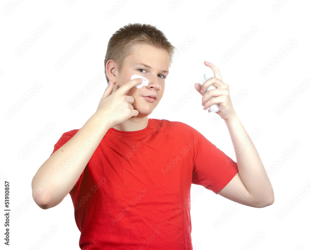 The boy,the teenager with a cream for a problem youthful skin The boy,the teenager with a cream for a problem youthful skin