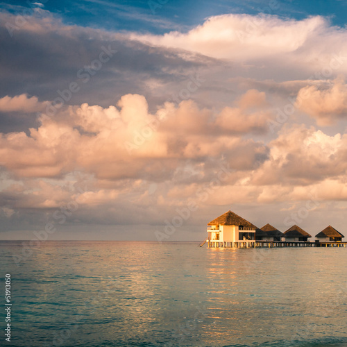 Sunset on Maldives island, water villas resort © fotomaximum