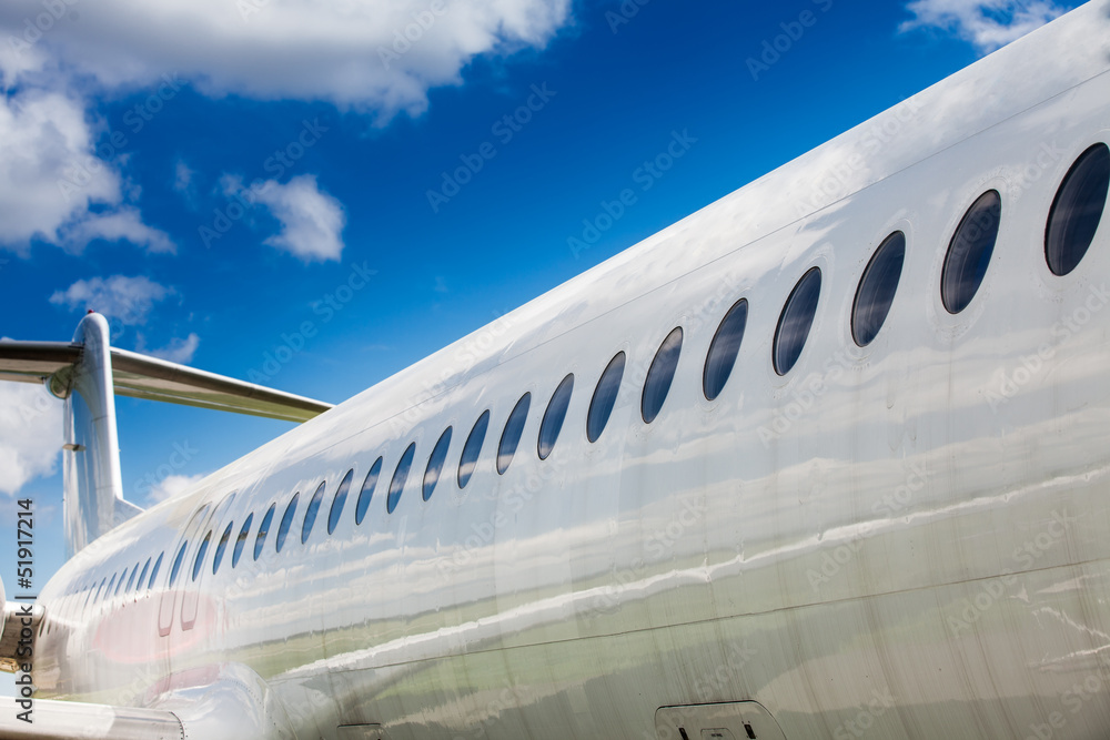 Windows and fuselage of a private airplane with tail section Windows and fuselage of a private airplane with tail section