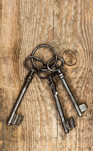 antique keys over dirty wooden background