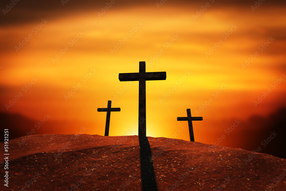 a sunset or sunrise of three crosses on a hill. clipping path