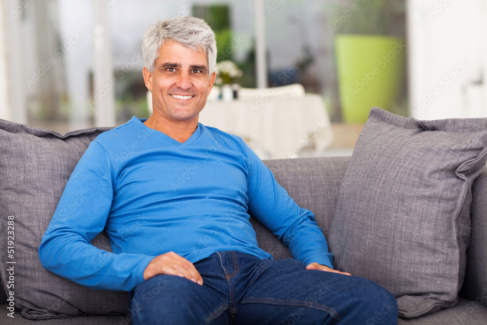 middle aged man relaxing on sofa