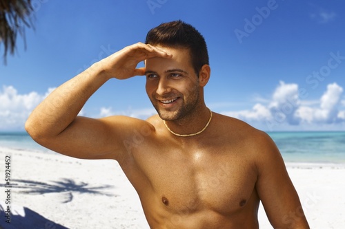 Athletic young man on the beach