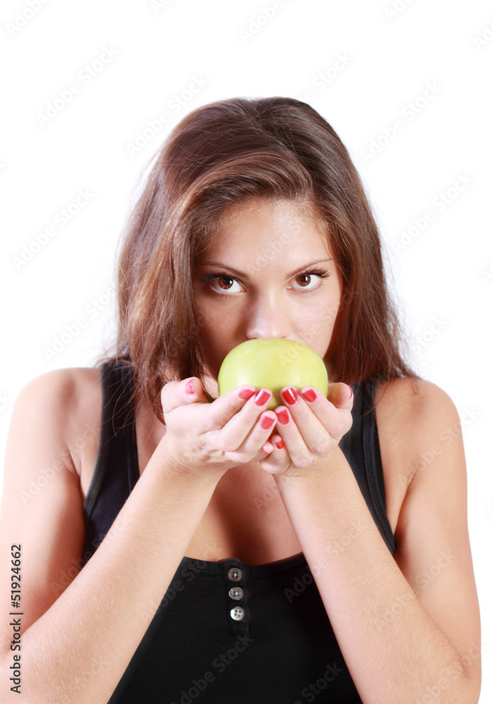 Beautiful brunette girl sniffs green apple isolated on white Beautiful brunette girl sniffs green apple isolated on white
