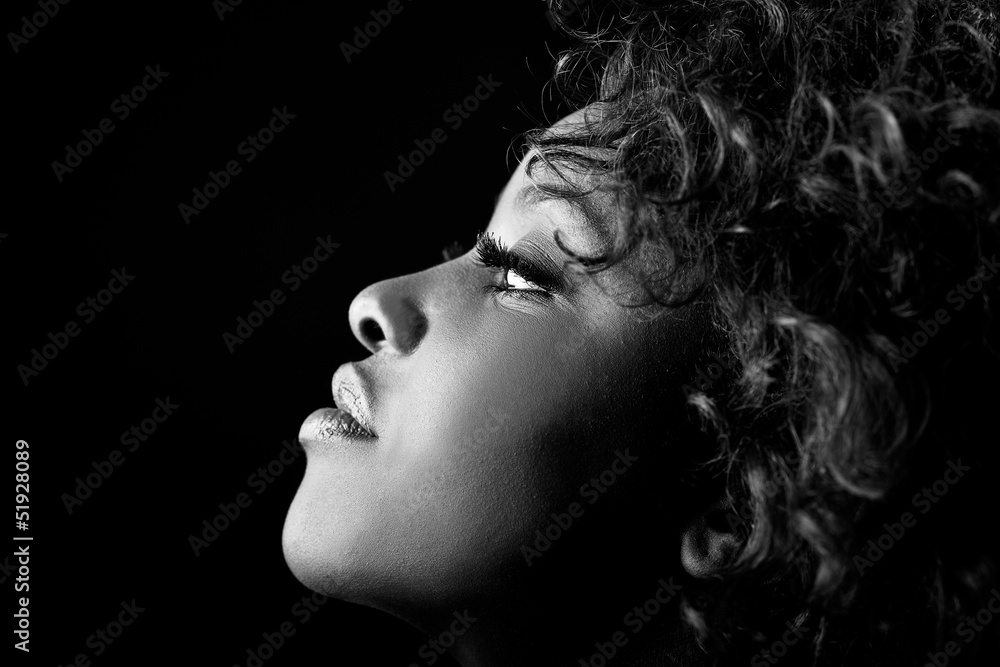 Beautiful black woman on black background. Studio shot