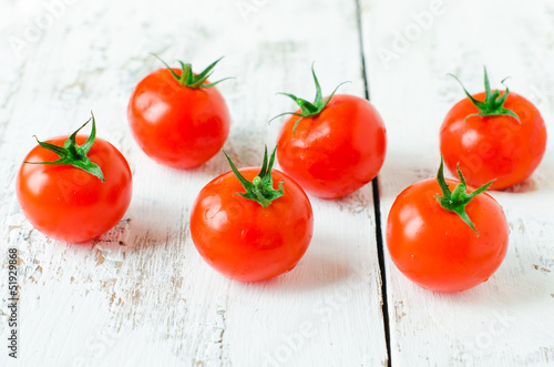 Fresh tomatoes on the wooden background