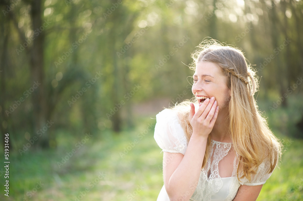 Portrait of a beautiful young woman laughing outdoors Portrait of a beautiful young woman laughing outdoors