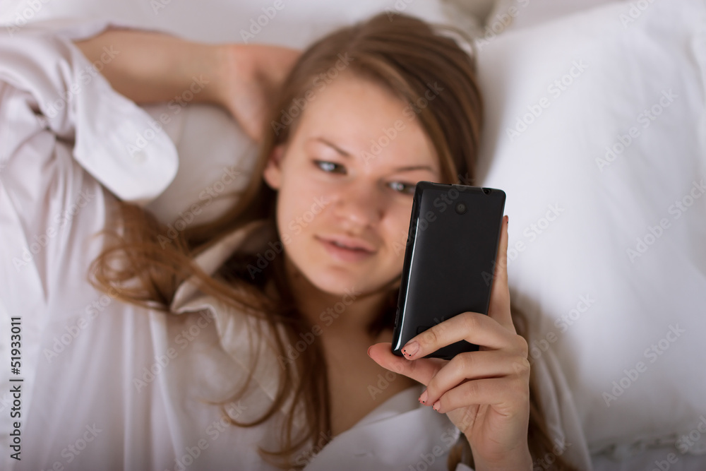 woman sending a text with mobile phone woman sending a text with mobile phone