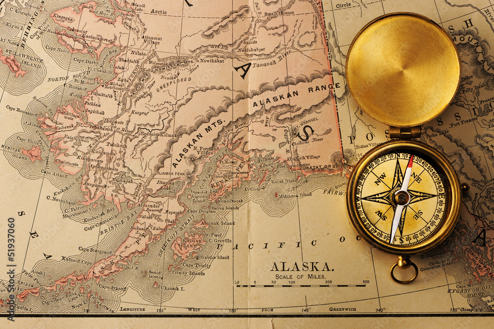 Antique compass over old XIX century map