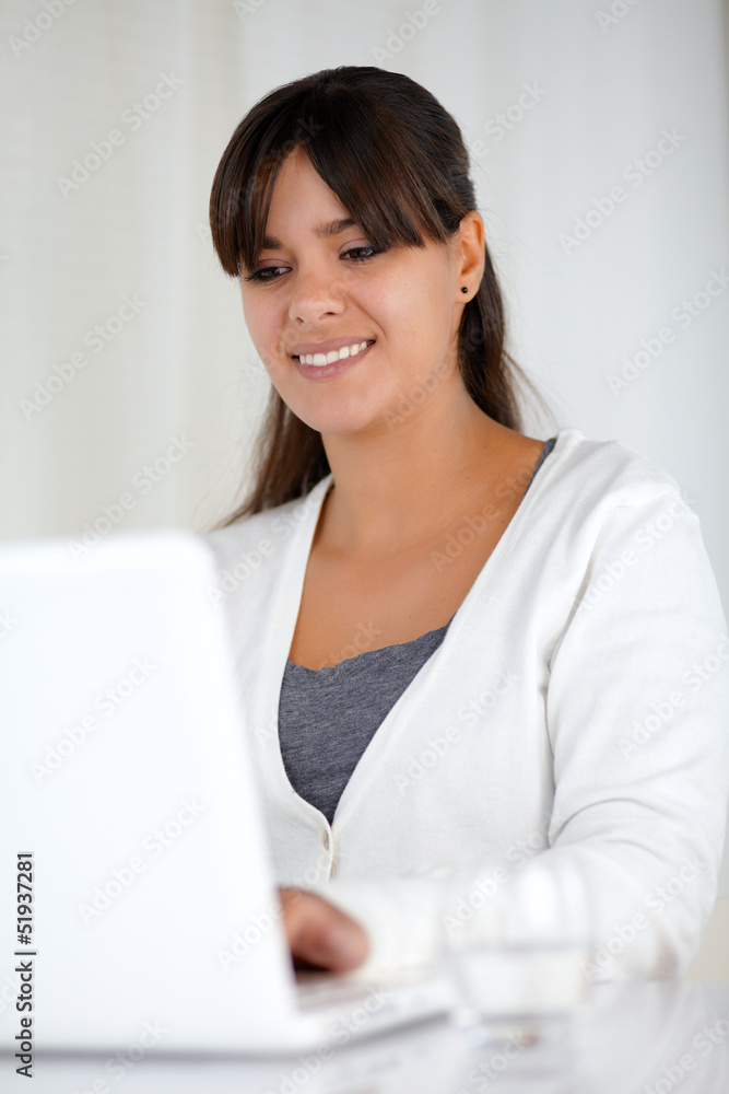 Smiling young female working with laptop computer Smiling young female working with laptop computer
