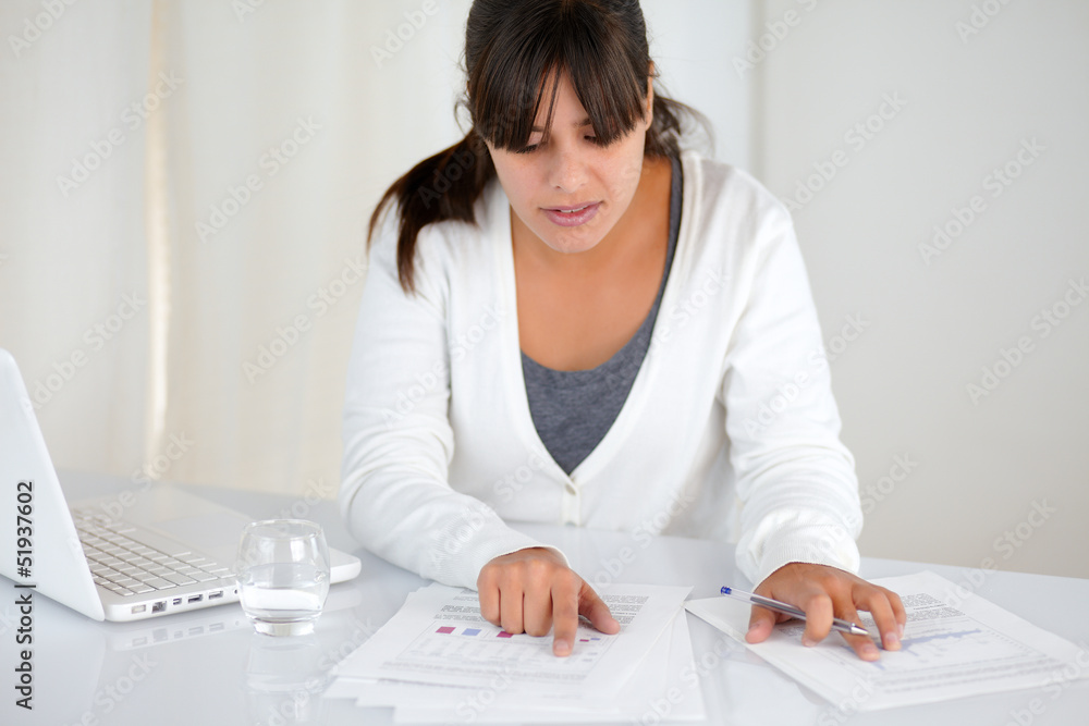 Charming young woman working with documents Charming young woman working with documents