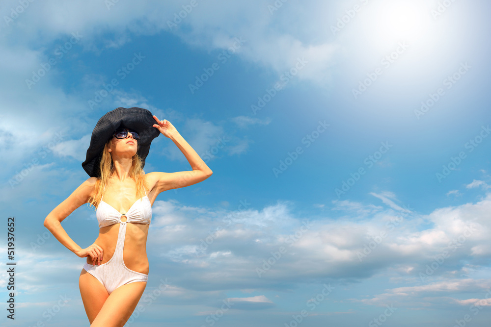 Bikini model over sky background