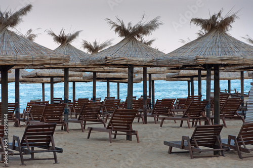 Lounge chairs with a sun canopy on the beach.