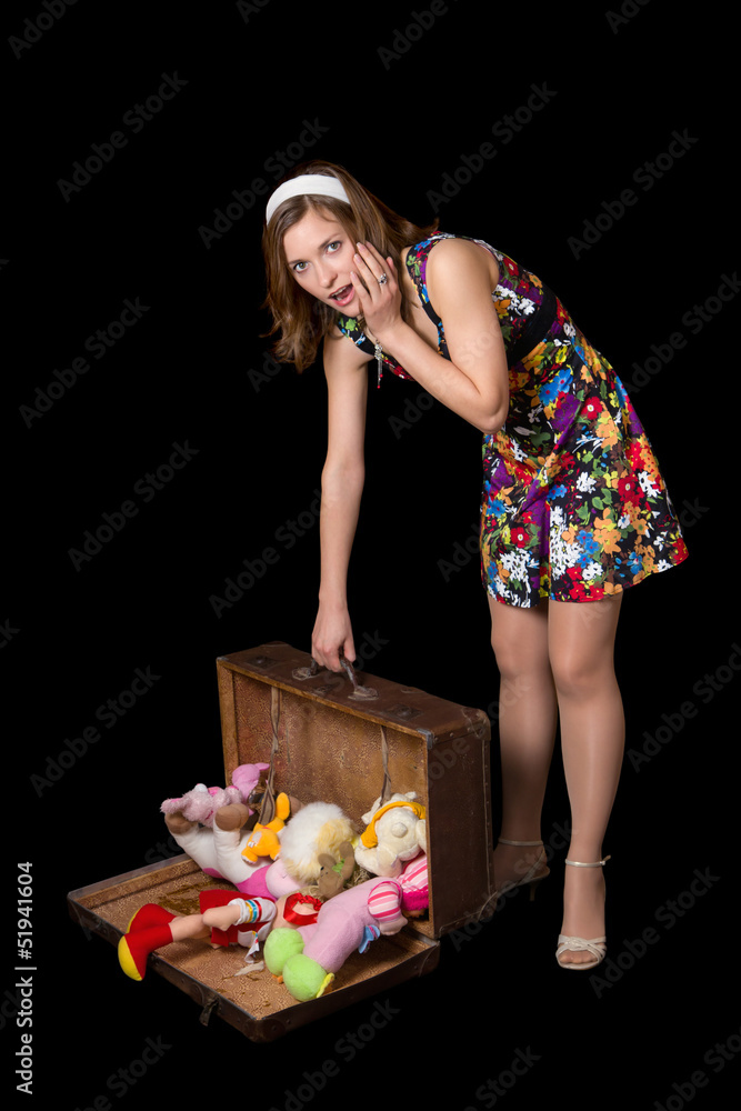 Young pinup woman with old opened suitcase Young pinup woman with old opened suitcase
