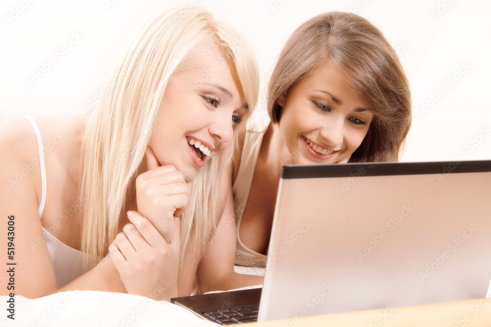 Two beautiful female friends browsing internet. Selective focus Two beautiful female friends browsing internet. Selective focus