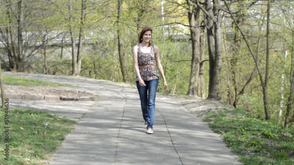beautiful girl walks through the park alley beautiful girl walks through the park alley