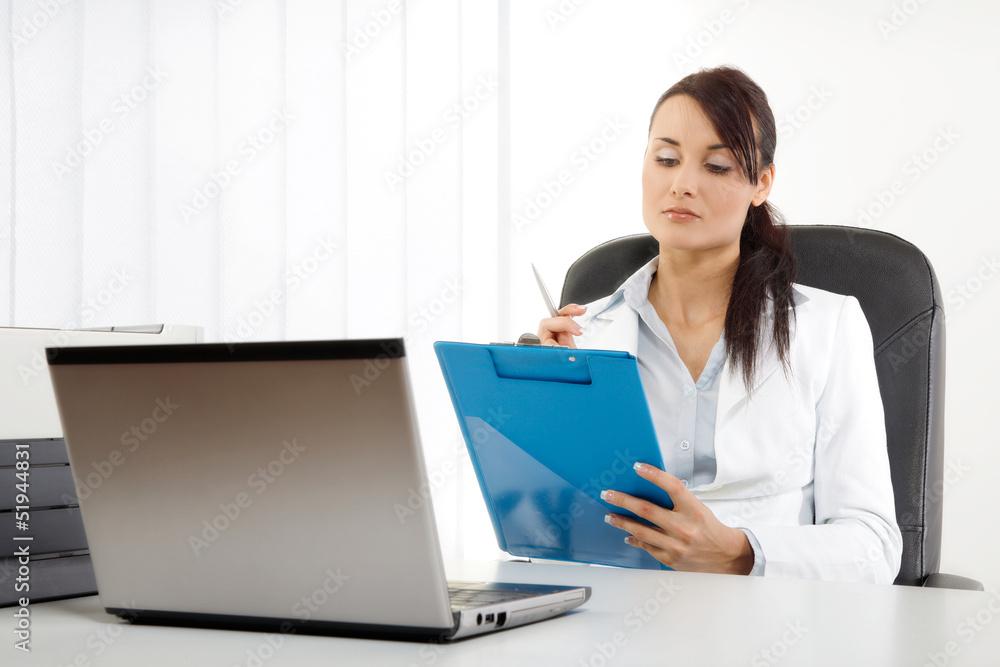 Young businesswoman holding coffee while at work Young businesswoman holding coffee while at work