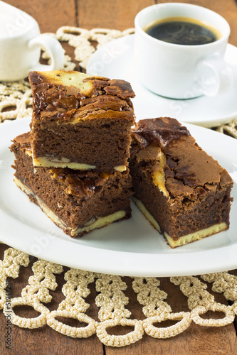 Cream cheese brownies on a white plate