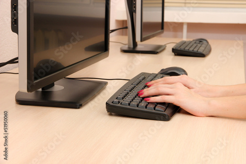 Female hands typing on keyboard
