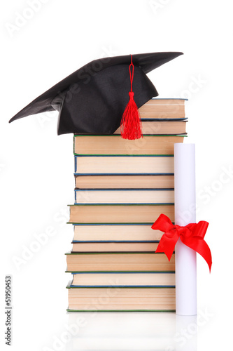 Grad hat with diploma and books isolated on white