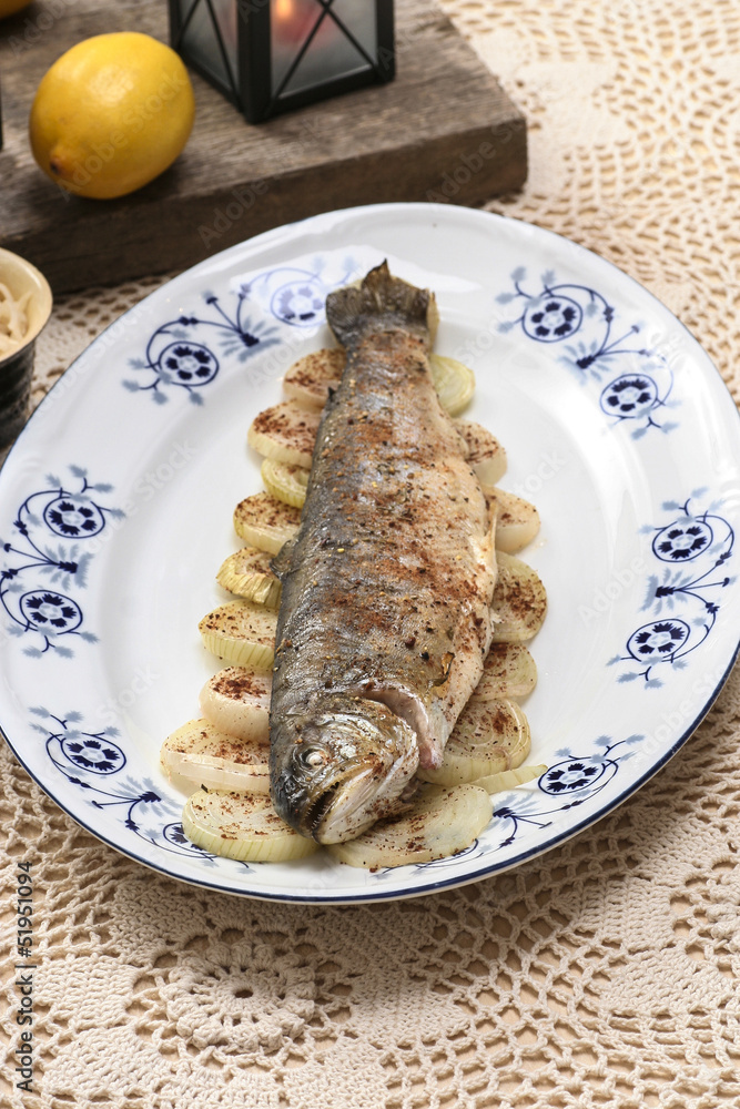 Fish plate in greek tavern. Roasted trout on onion. Fish plate in greek tavern. Roasted trout on onion.