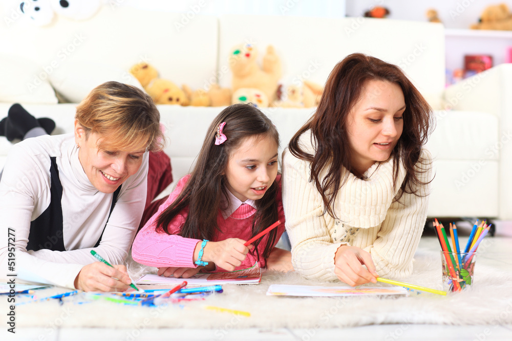 Beautiful girl draws with his mother and aunt. Beautiful girl draws with his mother and aunt.