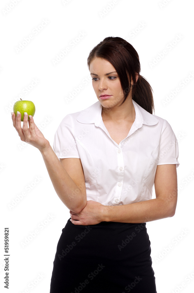 Business woman looking disappointingly at an apple Business woman looking disappointingly at an apple