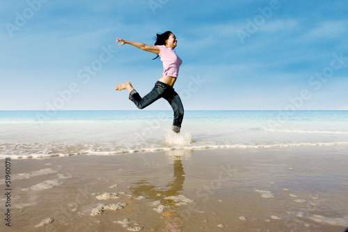 Asian girl jump at beach