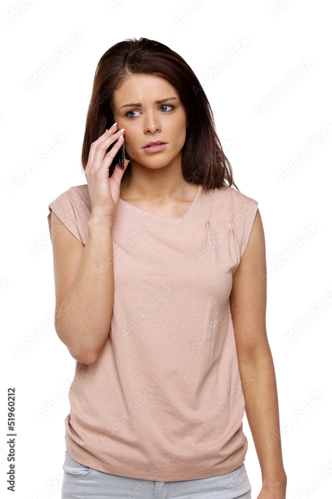 Brunette woman looking worried speaking on the phone Brunette woman looking worried speaking on the phone
