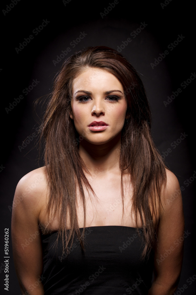 Beautiful brunette woman on a black background Beautiful brunette woman on a black background