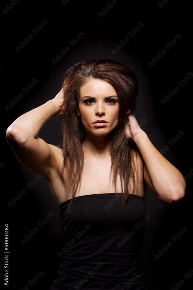 Beautiful brunette woman on a black background Beautiful brunette woman on a black background
